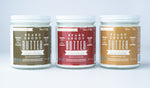Three Tallow Man Beard + Body Butter jars: Tobacco Vanilla, Old Time Barbershop and Bay Rum, on a pale studio background.